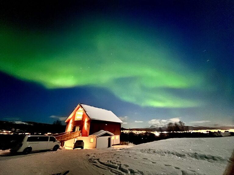 Northern lights over the Aurora Borealis Observatory lodge on Senja island, Norway