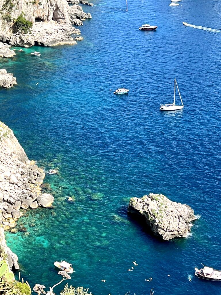 Turquoise water and sea rocks below the cliffs of Capri