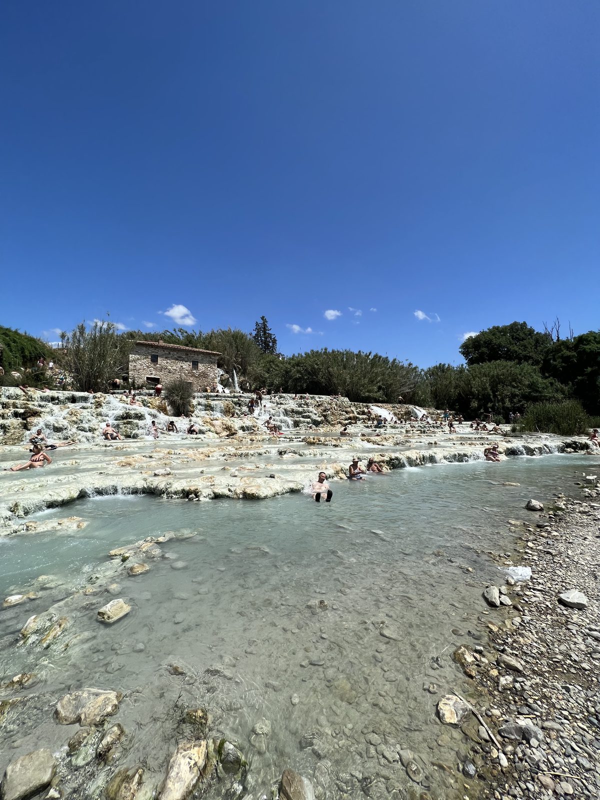 The terraced travertine pools and old stone mill at the Saturnia hot springs in Tuscany