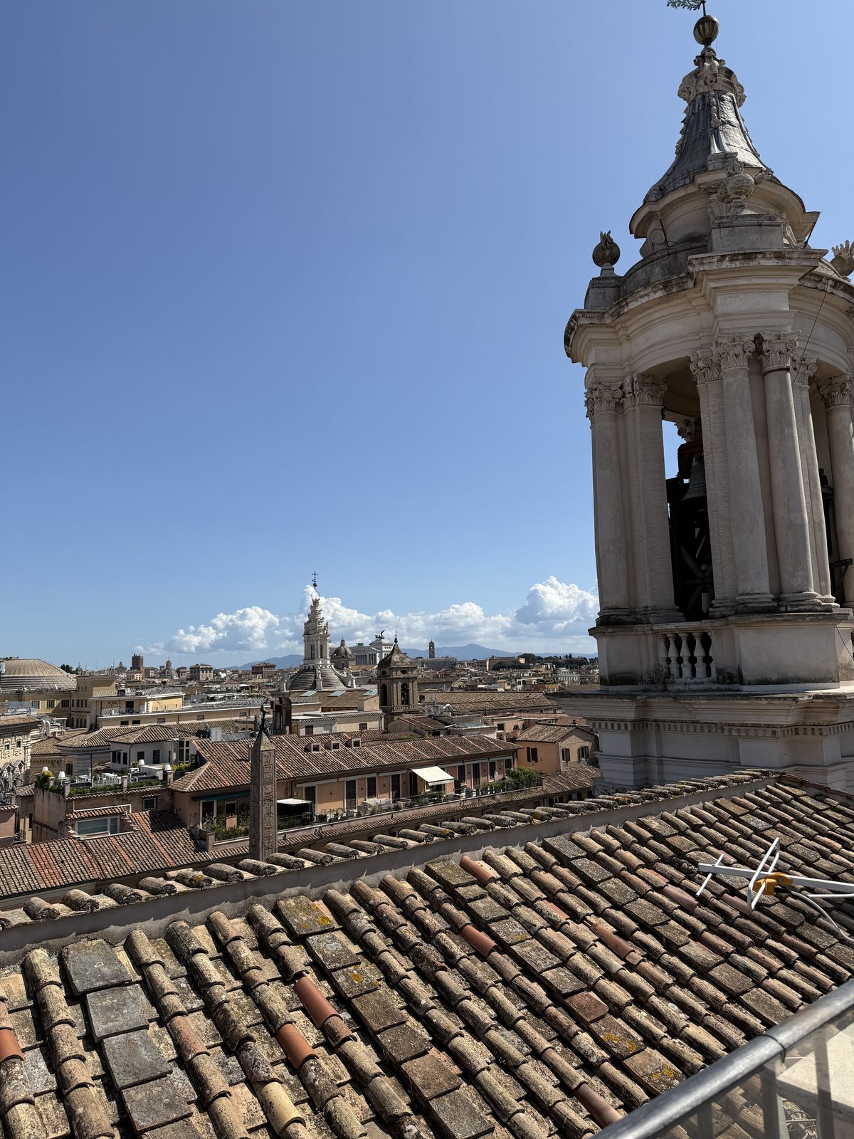 Rooftop view over the bell towers and tiled roofs of central Rome