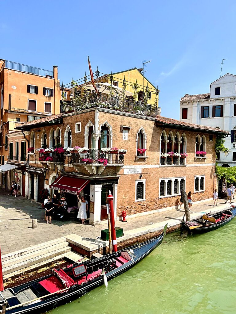 Trattoria alla Palazzina overlooking the canal in Venice with gondolas moored below