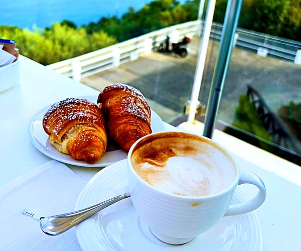 Cappuccino and pastries with a sea view at breakfast on the Amalfi Coast